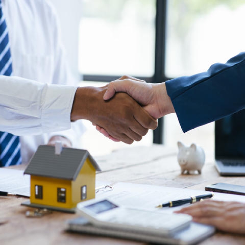 Close up shake hands, Considering buying a home, investing in real estate. Broker signs a sales agreement. agent, lease agreement, successful deal.